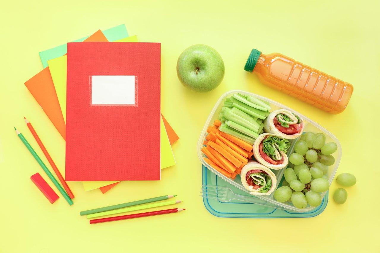 Une colorful finger foods lunchbox avec falafels, samoussas et rouleaux de printemps savoureux.